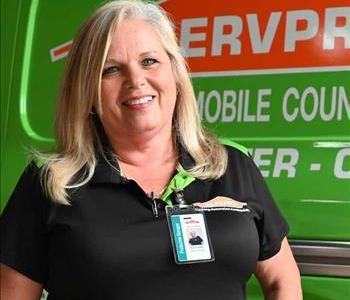 Kim in a SERVPRO shirt with a SERVPRO van