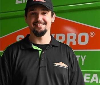 Stephen in a SERVPRO shirt with a SERVPRO van