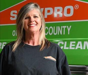 Vickie in a SERVPRO shirt with a SERVPRO van