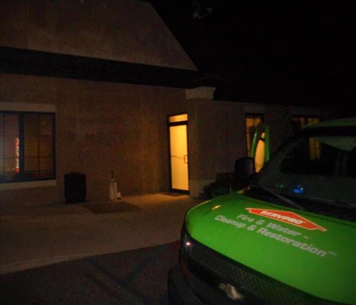 outside of building at night with green servpro van visible in the foreground