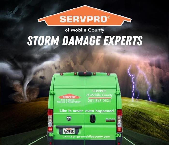 stormy background with green SERVPRO van driving down road