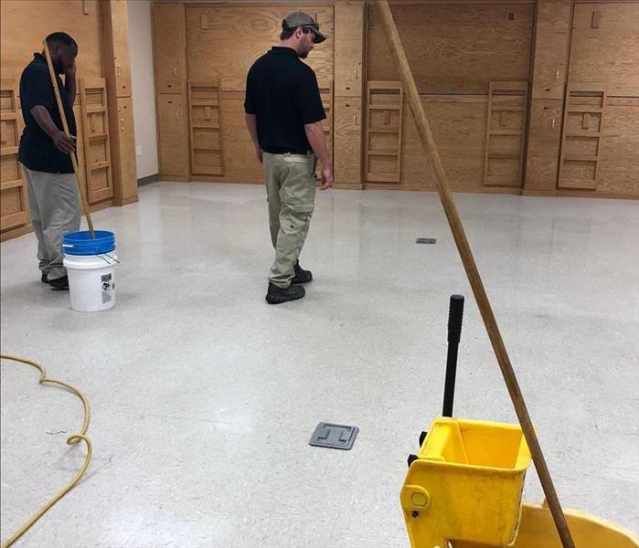 2 men mopping floor