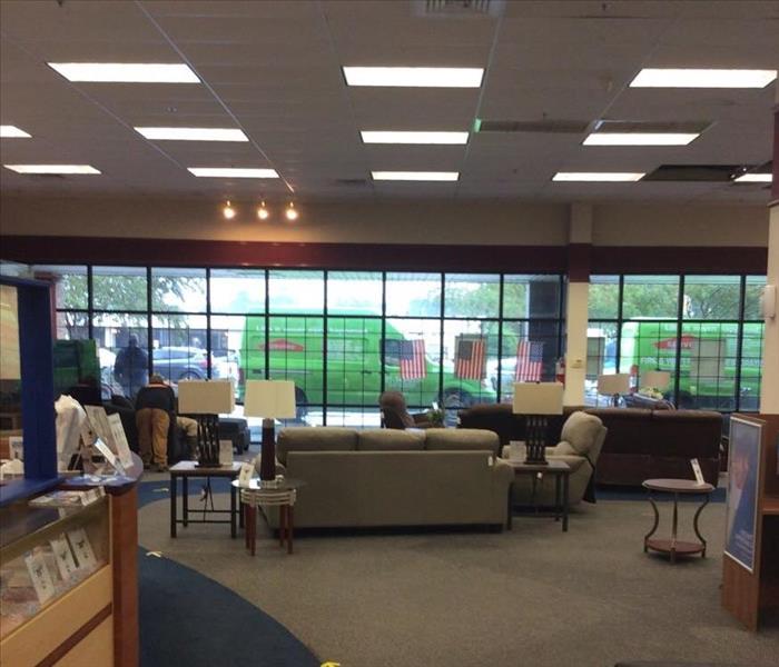 inside of showroom at commercial building with SERVPRO vans visible through window