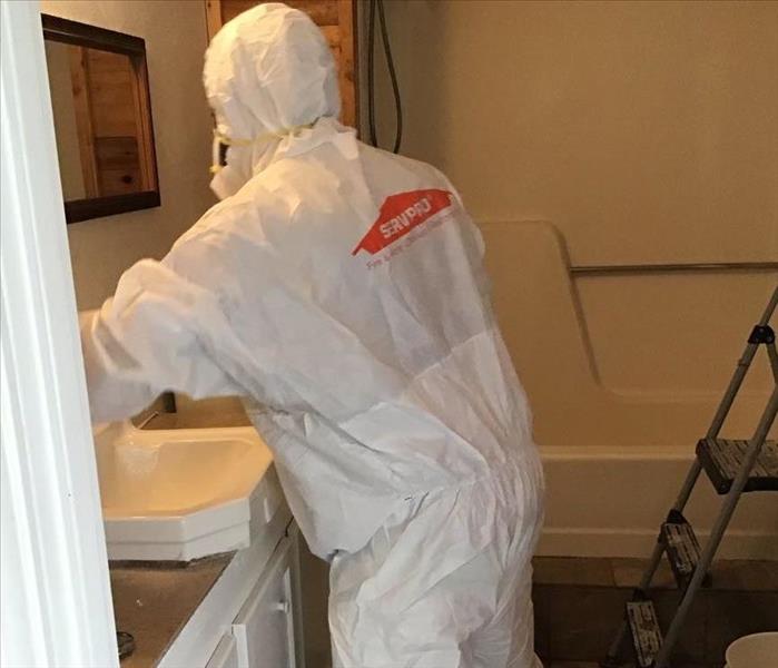 man in white tyvek suit with SERVPRO logo on back